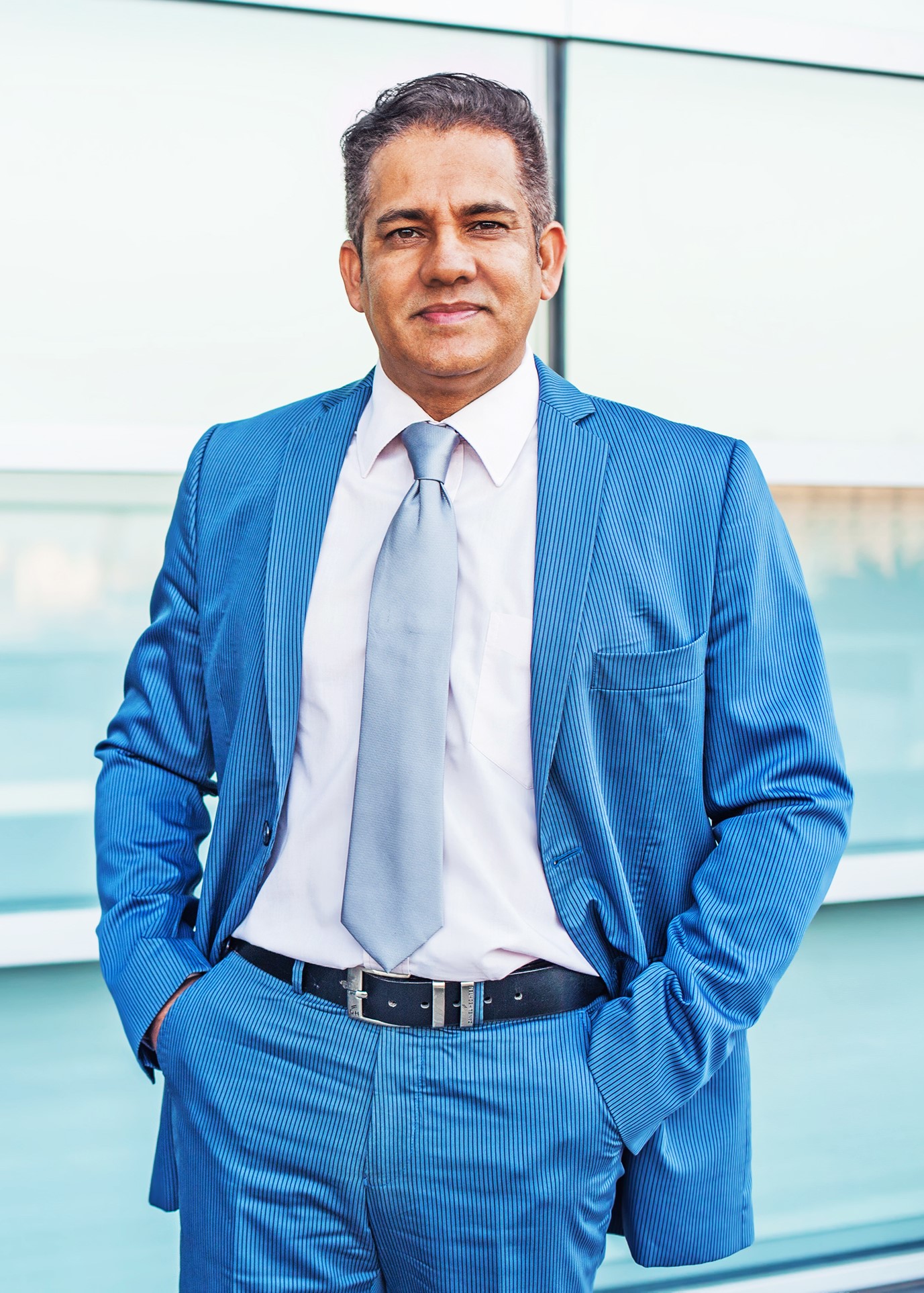 Man in a Bright Blue Suit Standing Outside